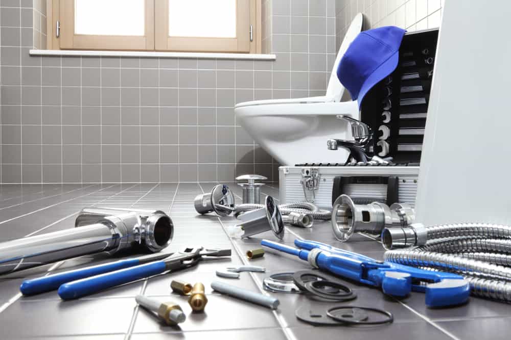 bathroom plumbing fixture with tools and equipment.