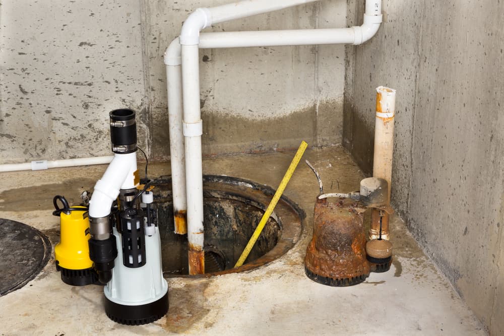 old damaged sump pump in a basement.